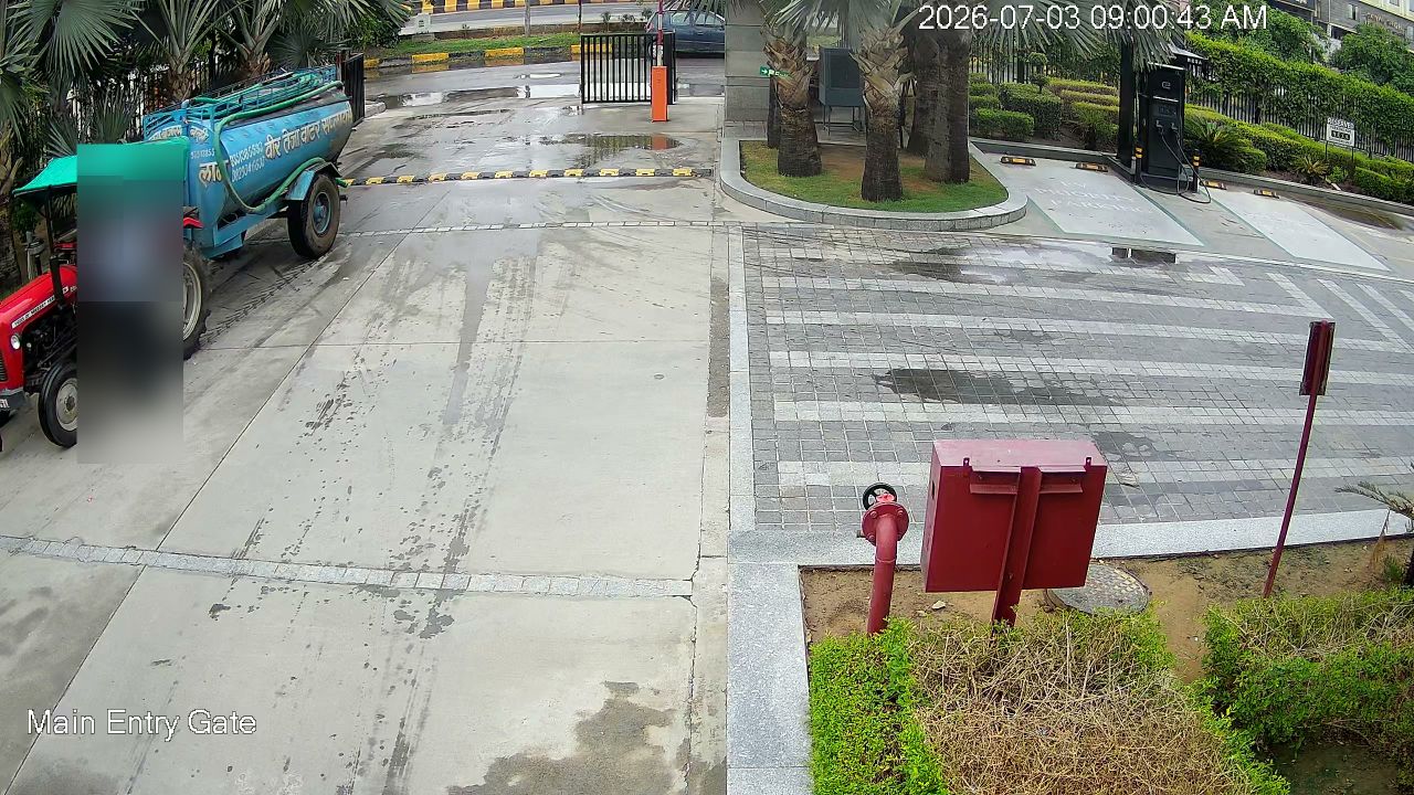Entry gate camera at a working dealership, faces masked