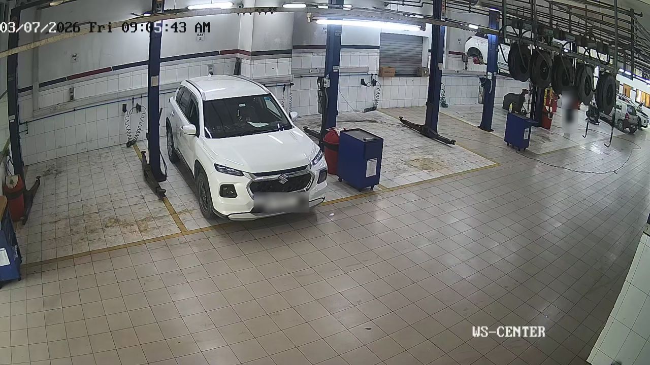 Workshop bay camera, technician masked